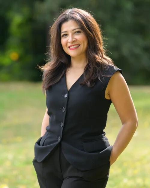 Outdoor personal branding portrait of a business owner in a black vest and trousers