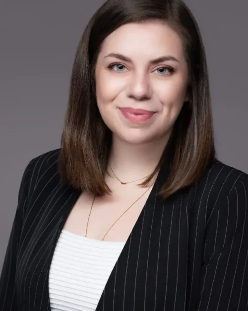 Professional headshot of Ester Gherea photographed on a grey backdrop in Langley