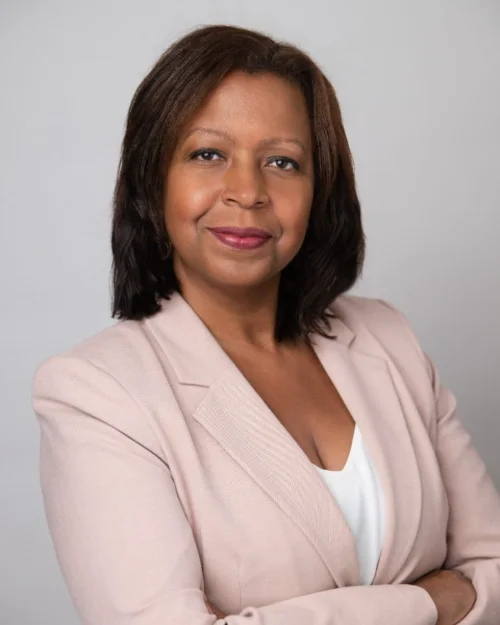 Professional headshot of a woman in a pink blazer photographed in Langley BC