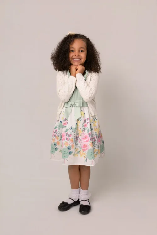 A girl in a floral dress photographed head to toe