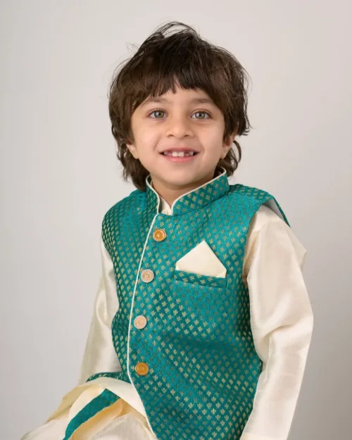 A boy in an embroidered teal waistcoat