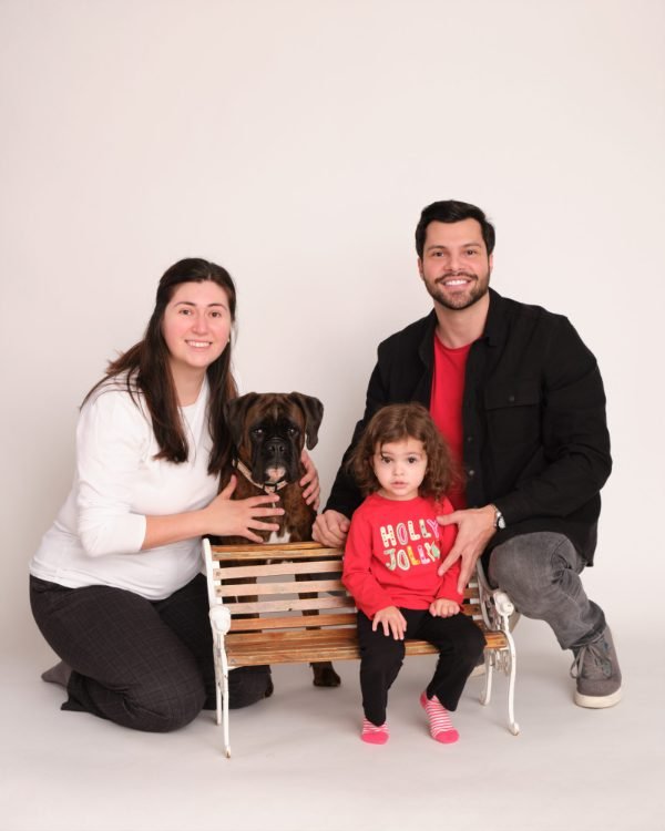 Family portrait with their dog on a studio bench at the Langley studio