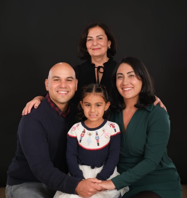 Family of four in white on a bright studio backdrop in Langley