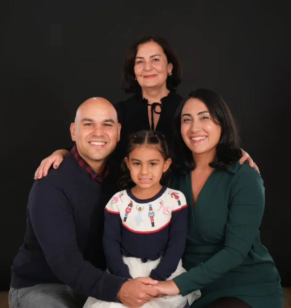 Family of four in white on a bright studio backdrop at the Langley studio