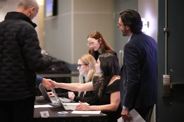 Guests checking in at the registration desk at the start of a corporate event