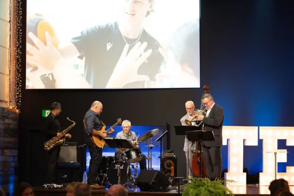 Live band performing on stage during the entertainment set at a corporate charity gala