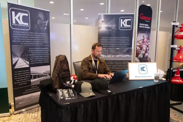 Exhibitor at a branded trade show booth during a BC industry conference