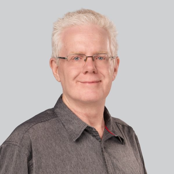 Career expo headshot of a man in glasses and a grey shirt