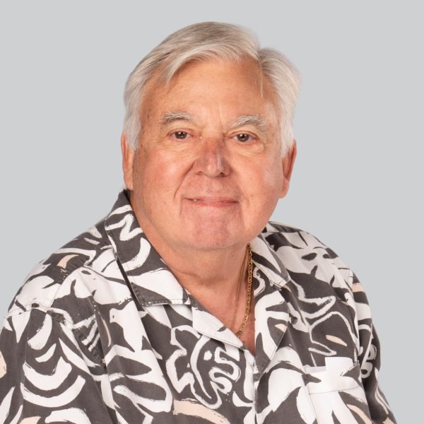 Career expo headshot of an older man with white hair in a patterned shirt