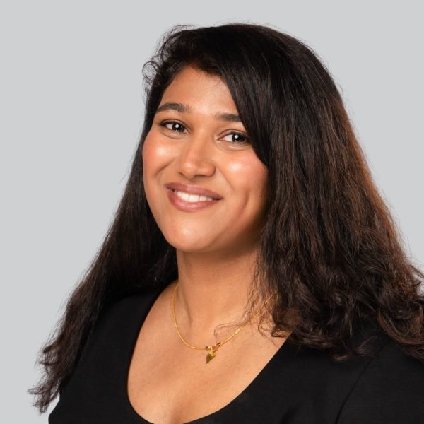 Career expo headshot of a woman with long curly hair in a black top