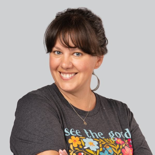 Career expo headshot of a smiling woman in a graphic t-shirt