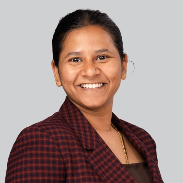 Career expo headshot of a woman in a dark red plaid shirt