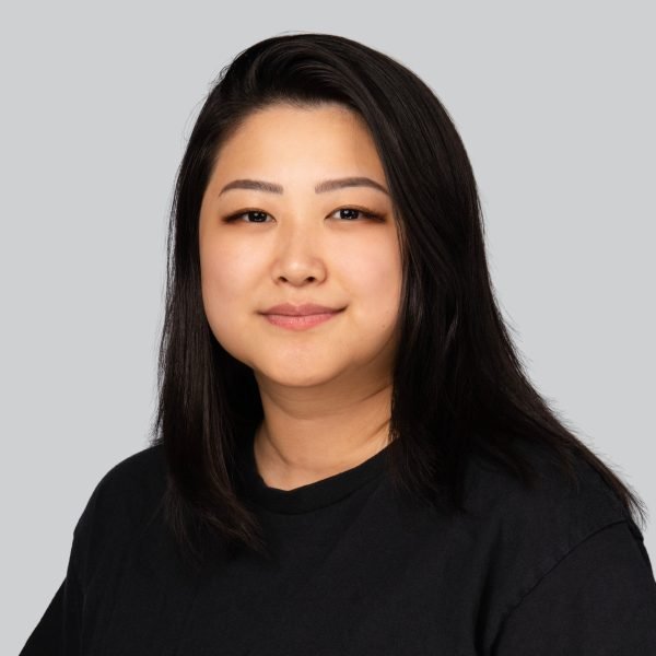Conference headshot of a woman with shoulder-length dark hair in a black top
