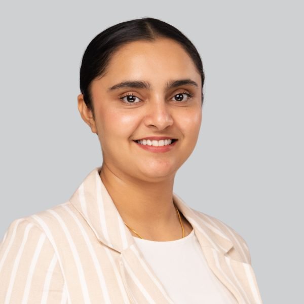 Conference headshot of a woman in a striped cream blazer at an event headshot booth