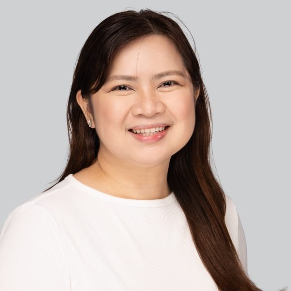 Event headshot booth portrait of a smiling woman in a cream knit top