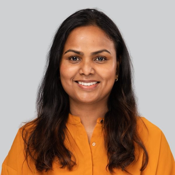 Event headshot booth portrait of a woman in a mustard blouse