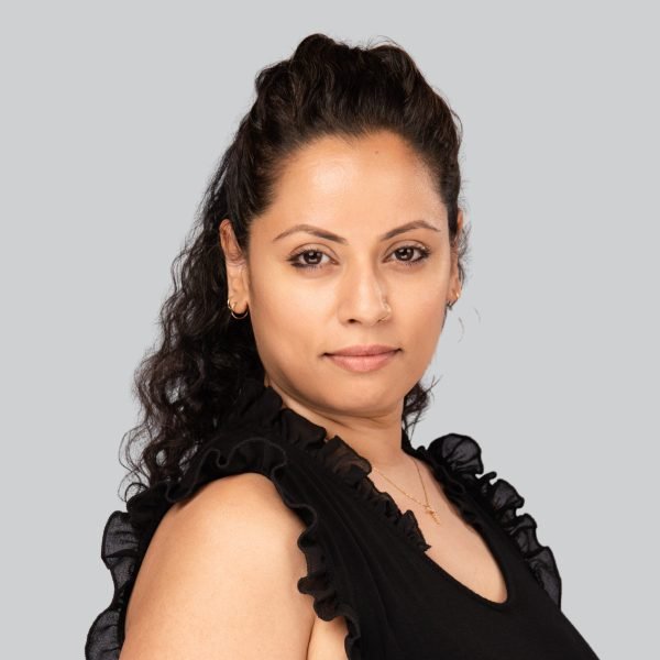 Event headshot of a woman with long dark hair in a black sleeveless top