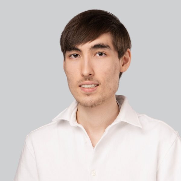 Event headshot of a young man with long hair in a white shirt