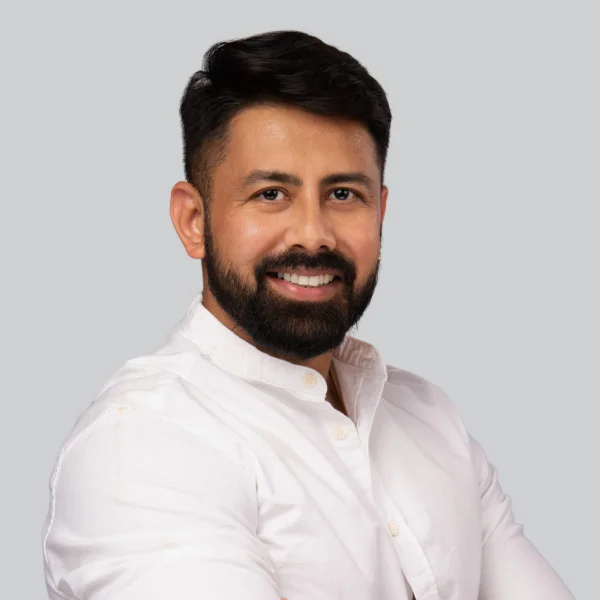 Event headshot booth portrait of a man with a beard in a white shirt