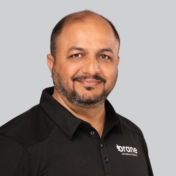 Trade show headshot of an exhibitor in a branded black polo shirt