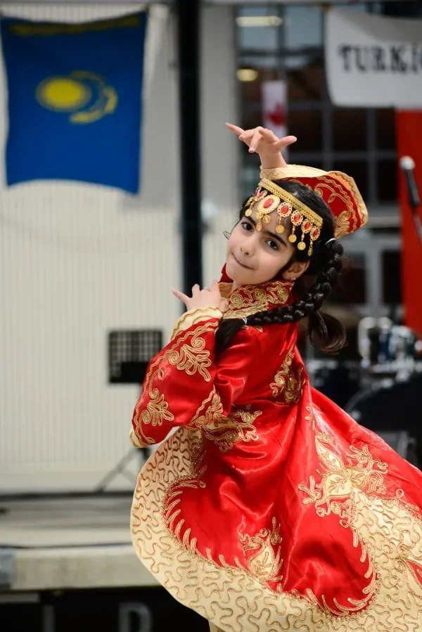 Festival dancer mid-spin in a red and gold traditional costume