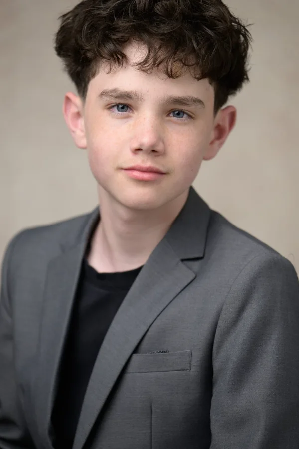Actor headshot of a young performer in a grey blazer photographed in Vancouver
