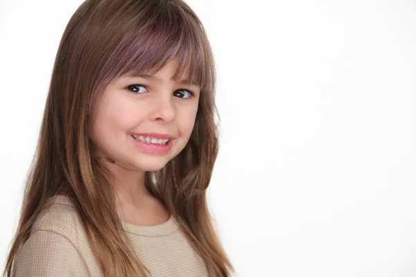 Smiling child actor headshot on a white background for casting