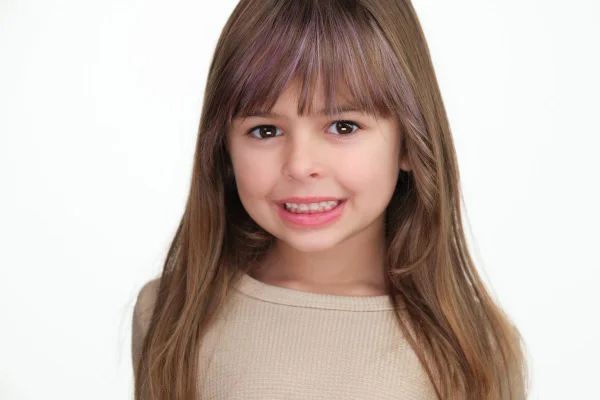 Child model headshot photographed on a white background in Langley BC