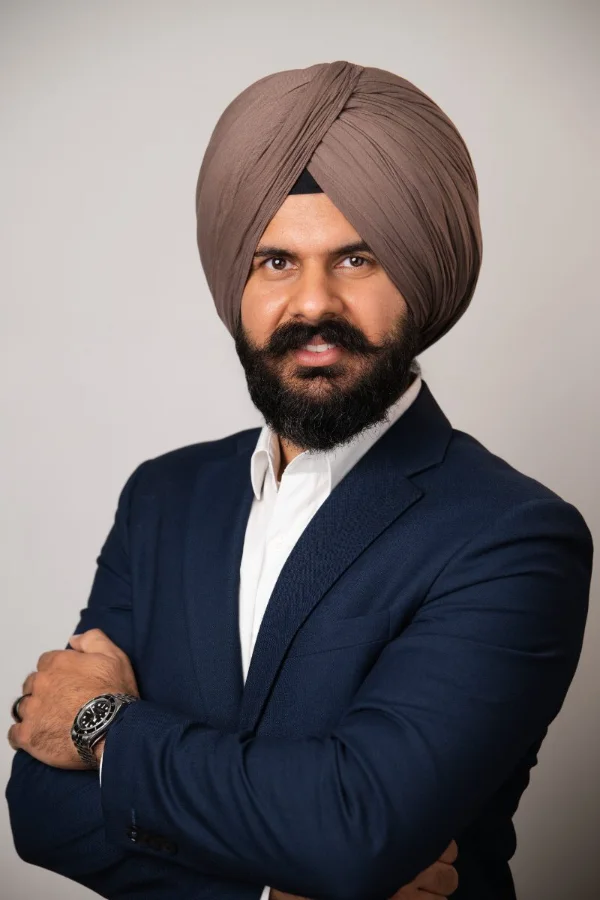 Lawyer headshot of Chand Karwal photographed on a light studio backdrop