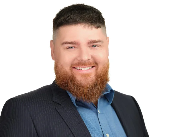 Professional headshot of Przemek Cerazy on a white background, Surrey area