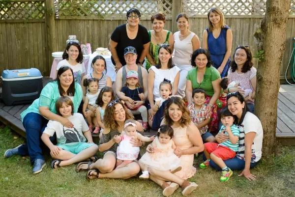 Baby shower group photo of guests gathered together in a backyard in the Lower Mainland