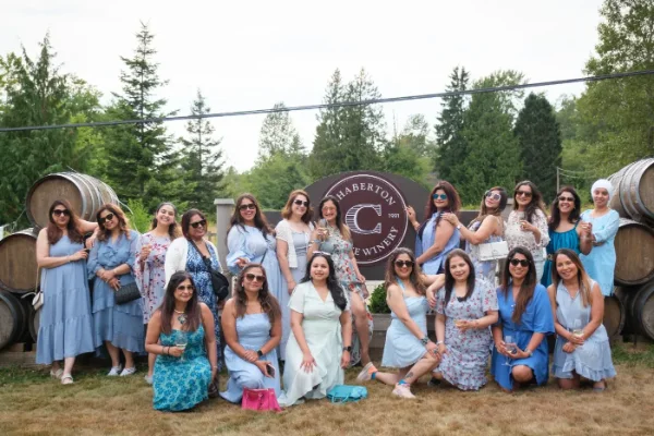 Bridal shower group photo of guests in matching blue dresses at a Fraser Valley winery