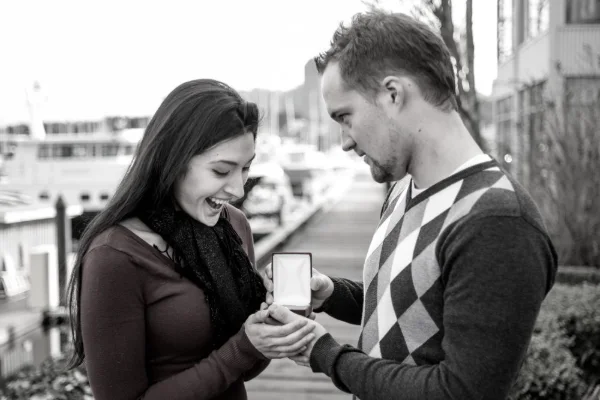 Surprise marriage proposal photographed at a marina as she sees the ring for the first time