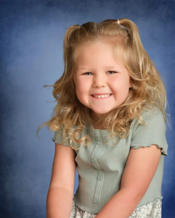 A school portrait on the traditional blue picture-day backdrop