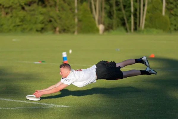 Ultimate frisbee player diving for a catch during a league game in Vancouver