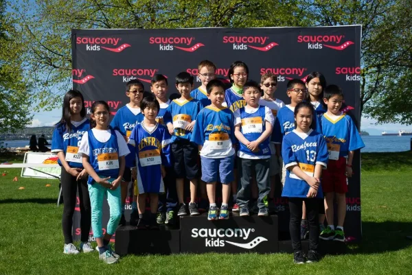Young athletes posing together at a kids running event