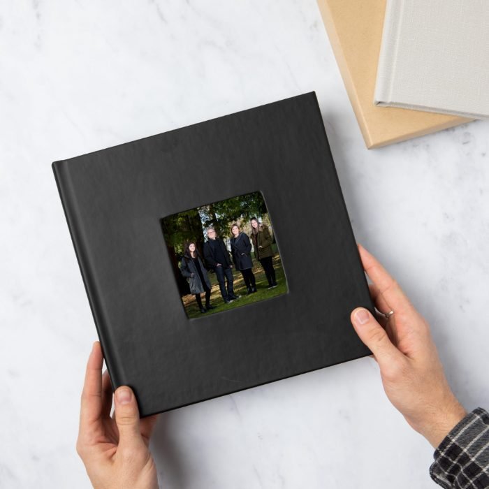 Black leather family album with an outdoor portrait inset in the cover