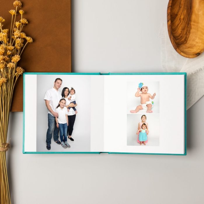 Open lay-flat family album showing a studio session spread across two pages