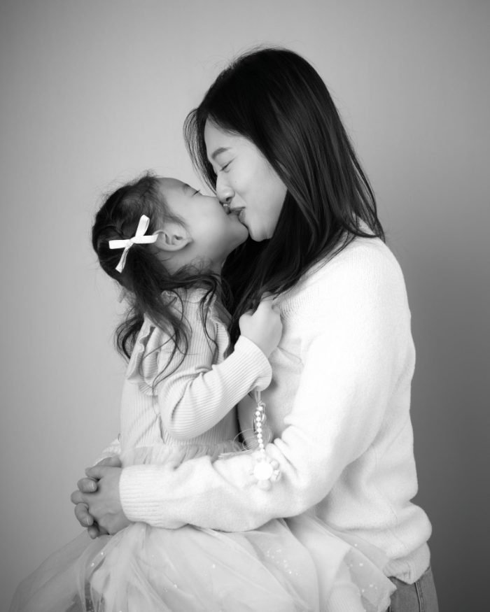 Black and white portrait of a mother and daughter, one panel of a three-piece triptych set