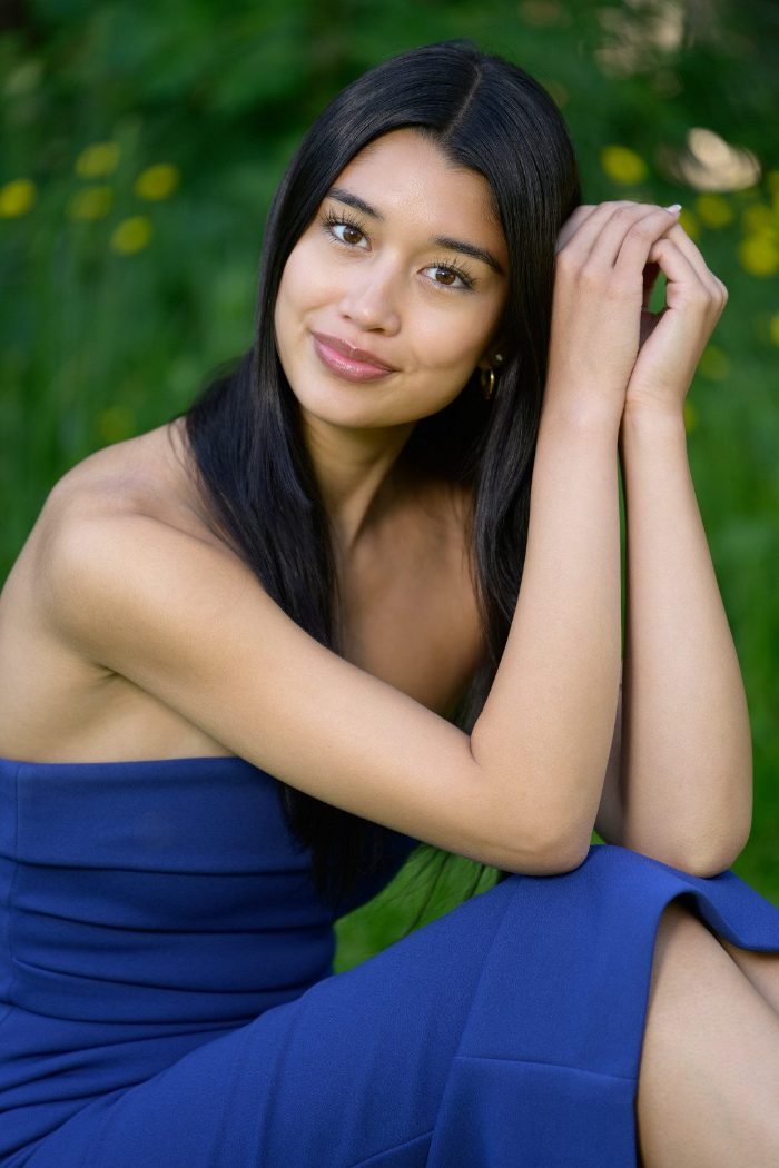 A BC graduate photographed outdoors in cap and gown
