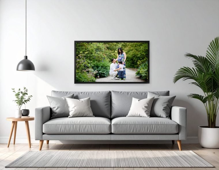 Framed family portrait hanging above a sofa in a bright living room