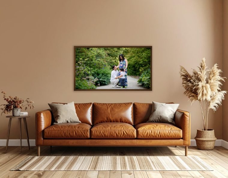 Large framed family print displayed above a tan leather couch