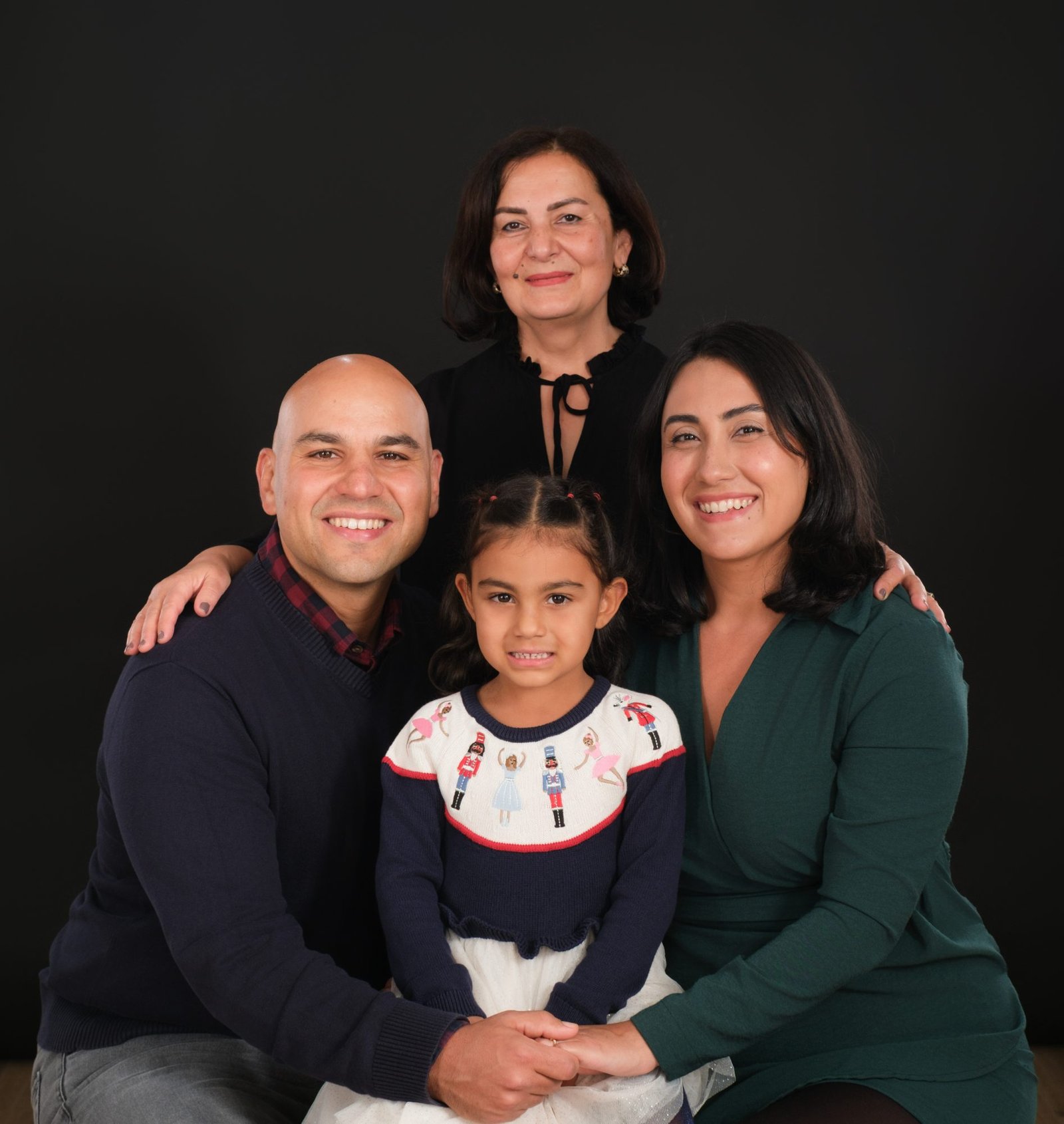 Family of four in white on a bright studio backdrop at the Langley studio