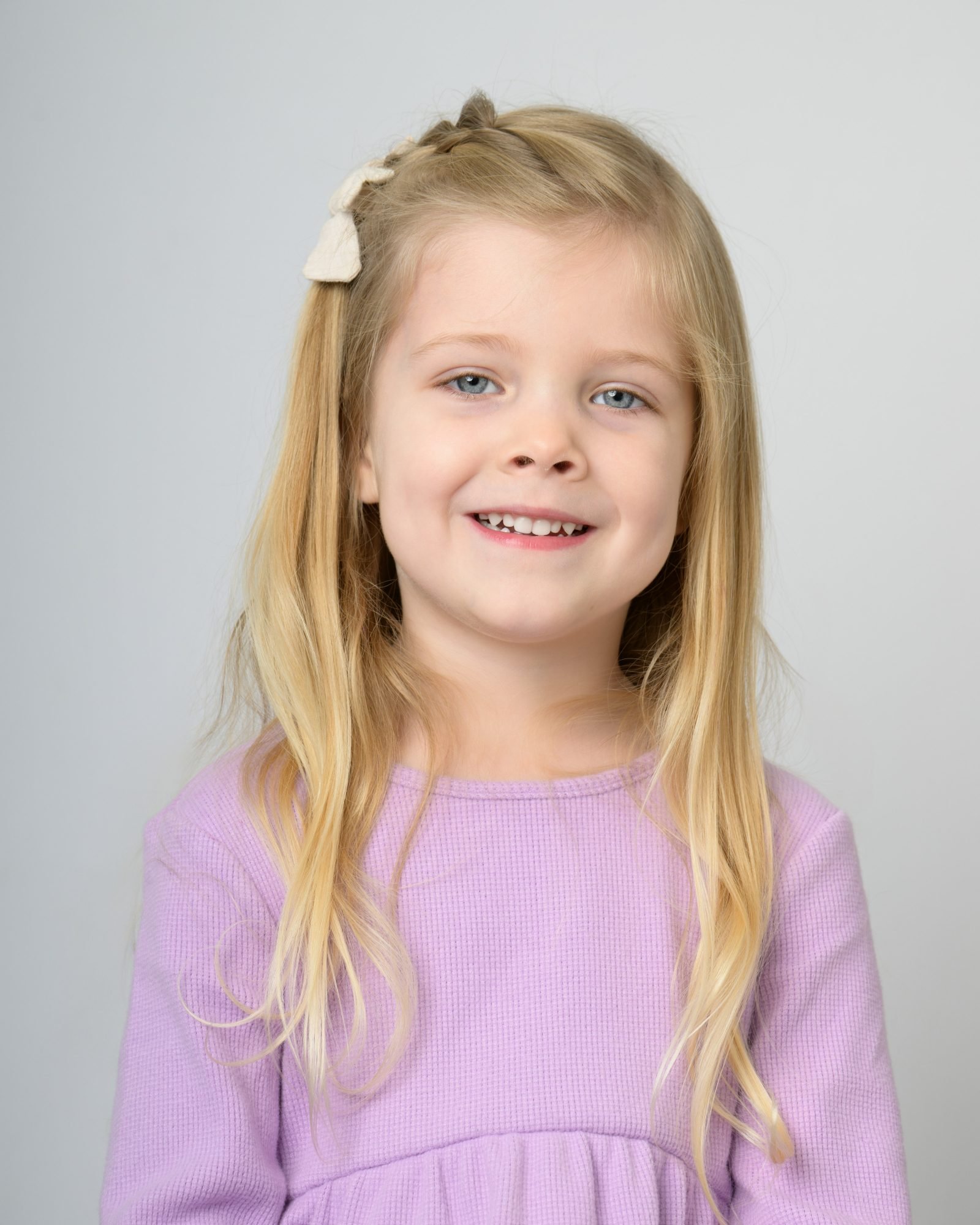 A child warming up at her own pace on preschool photo day