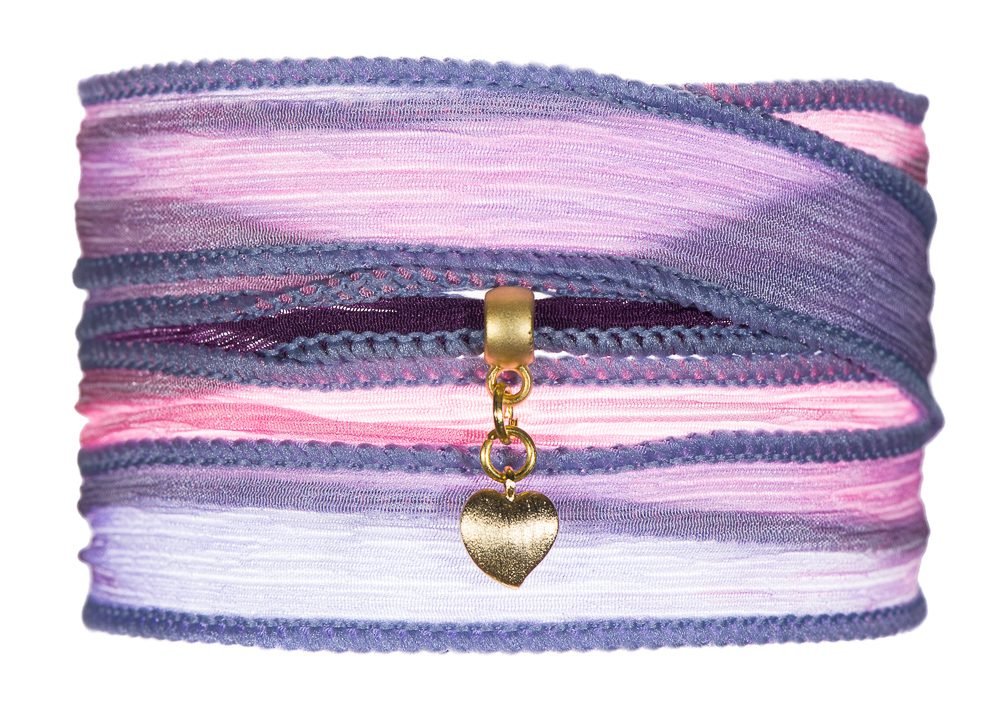 Jewellery product photography of a hand-dyed silk wrap bracelet with a gold heart charm on white