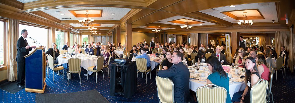 Panoramic view of the full banquet room during an association awards dinner at a Vancouver waterfront club