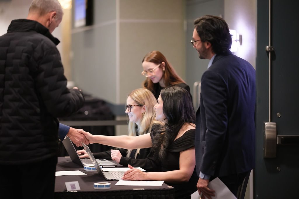 Guests checking in at the registration desk at the start of a corporate event