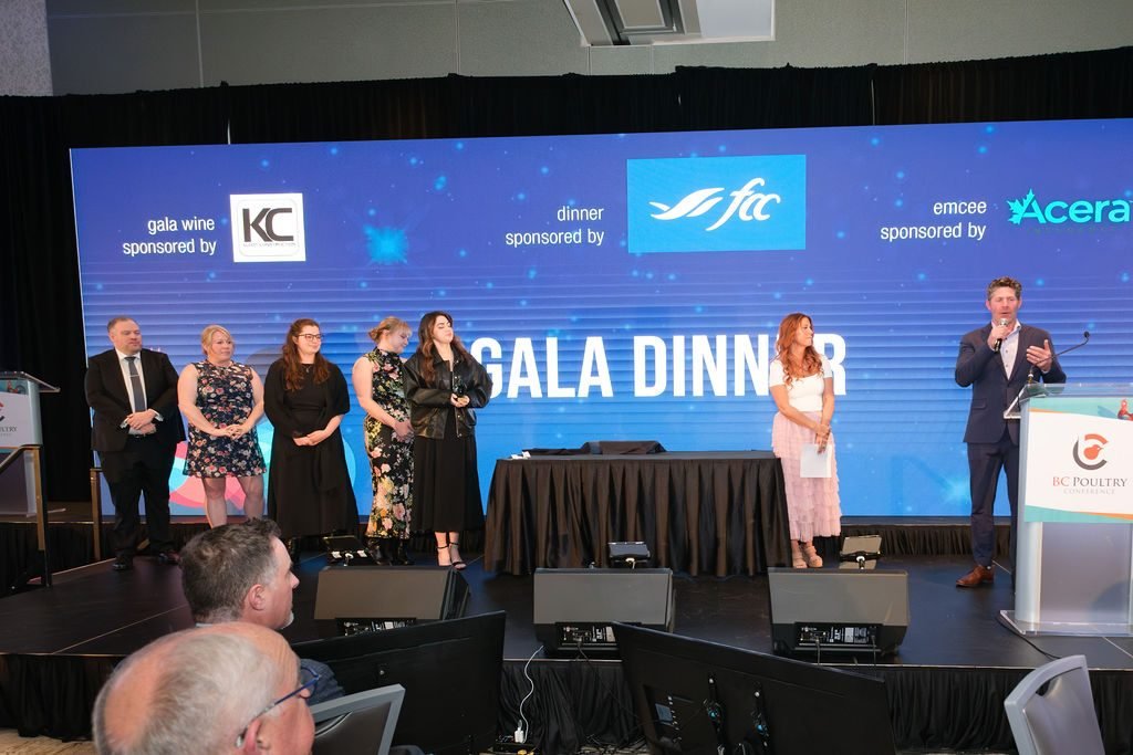 Hosts welcoming guests from the stage at a sponsored corporate gala dinner in Vancouver