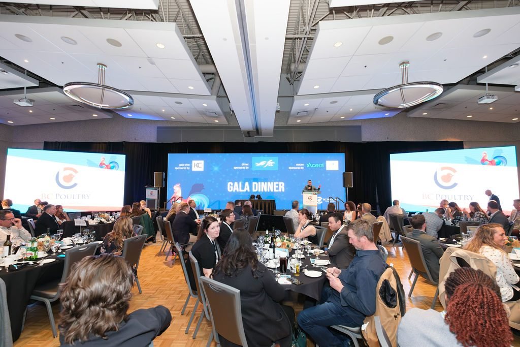 Guests at banquet tables watching the program during a corporate gala dinner