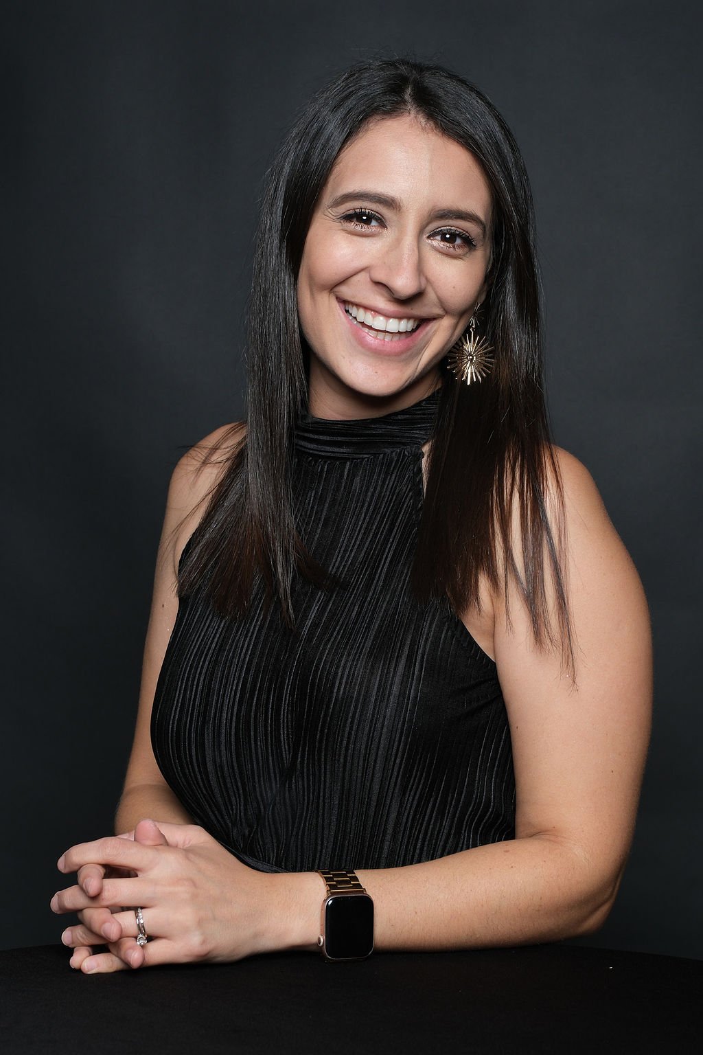 Guest photographed on her own at the gala portrait booth in a black evening dress